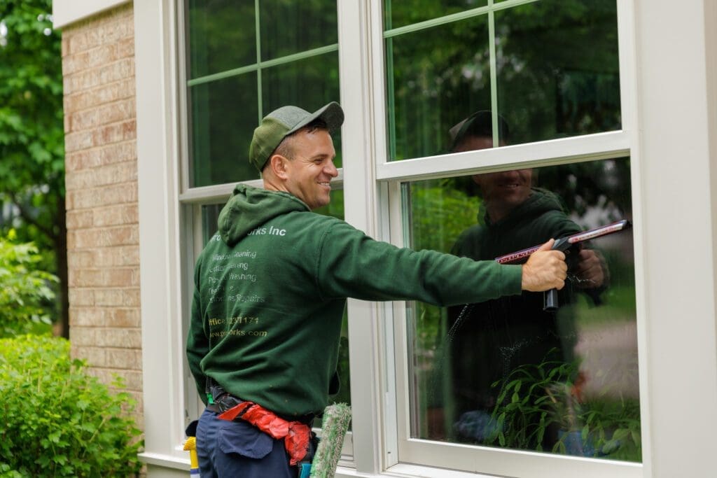 man washing a double hung window