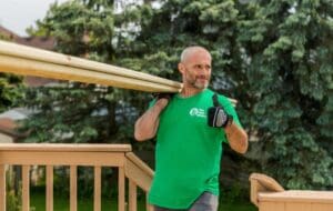 A man carrying timber for deck building.