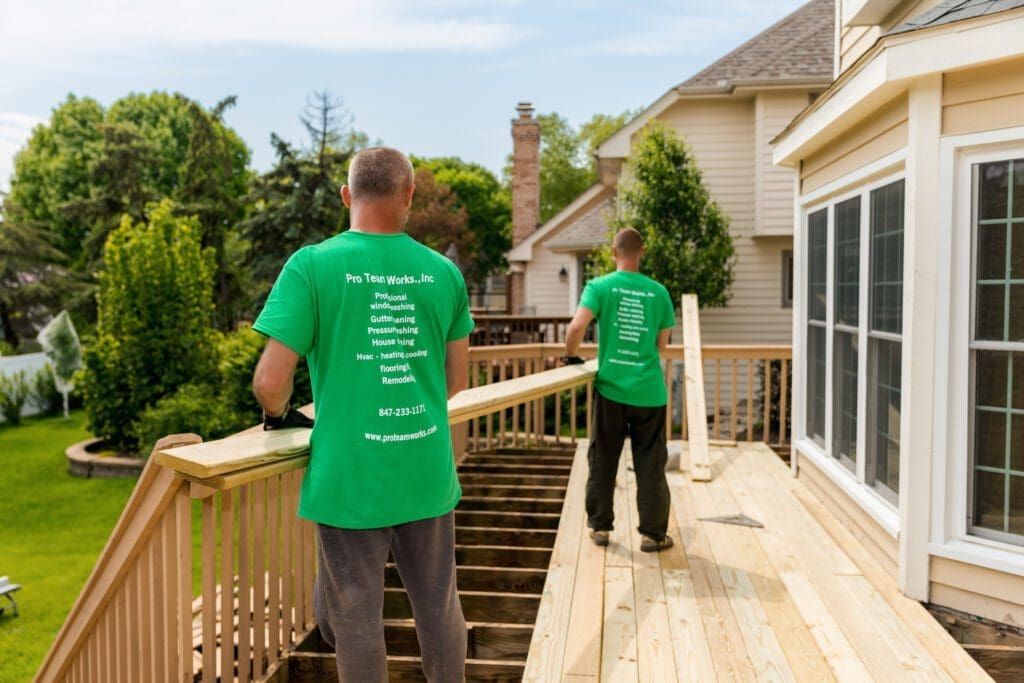 deck maintenance services carrying wooden plank