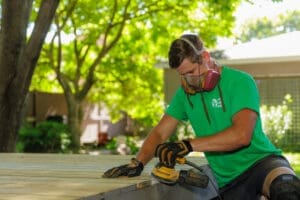 Wooden deck being smoothed with a sander